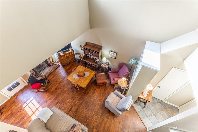 living room with hardwood / wood-style flooring and a high ceiling