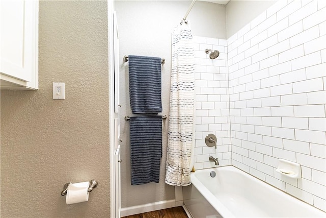 bathroom with shower / bath combo with shower curtain