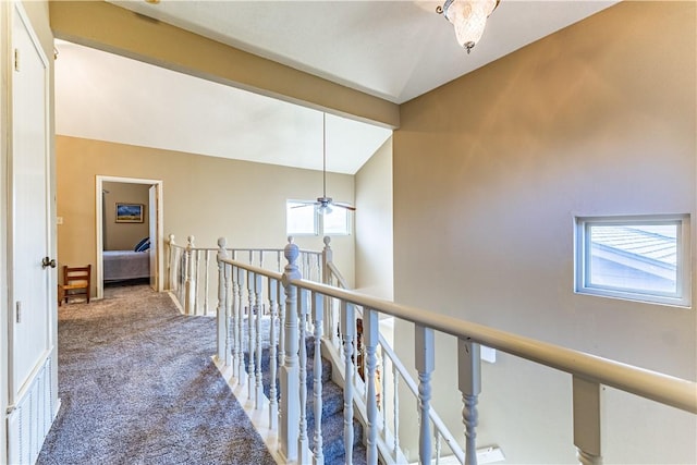 hallway featuring carpet and lofted ceiling with beams