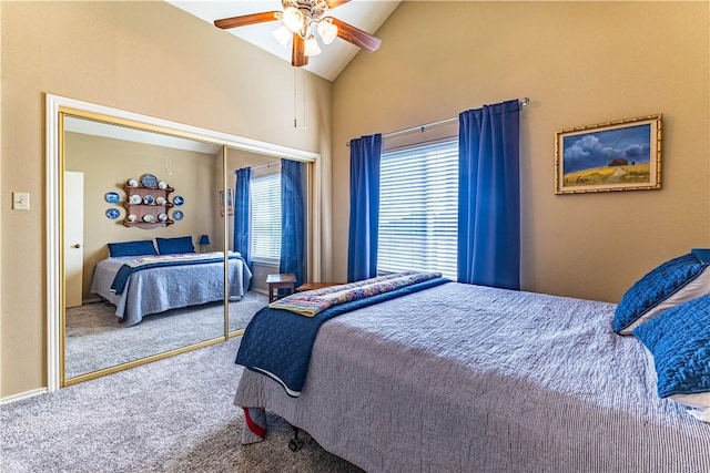 carpeted bedroom featuring ceiling fan, a closet, and lofted ceiling