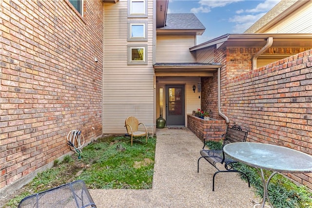 entrance to property featuring a patio