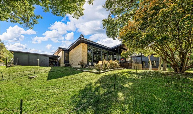 view of property exterior featuring a yard and central AC