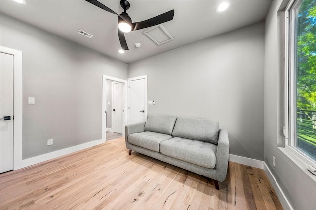 living area featuring ceiling fan and light hardwood / wood-style flooring