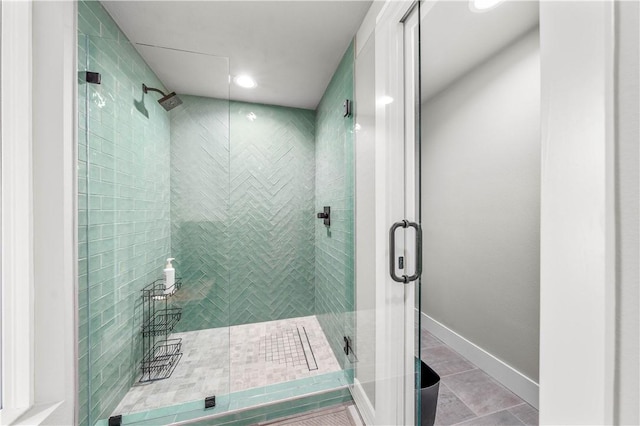 bathroom featuring a shower with shower door