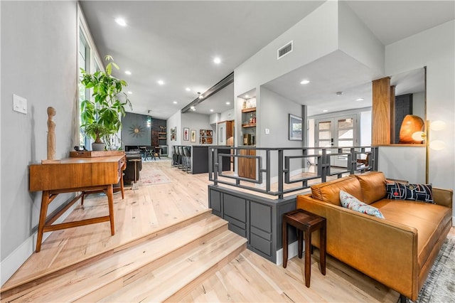 living room with french doors and light wood-type flooring