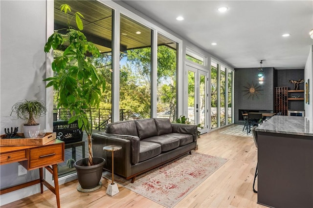 interior space with a wealth of natural light, french doors, and light wood-type flooring