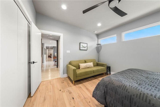 bedroom featuring ceiling fan, a closet, and light hardwood / wood-style floors