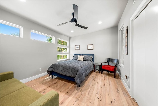 bedroom with wood-type flooring, a closet, and ceiling fan