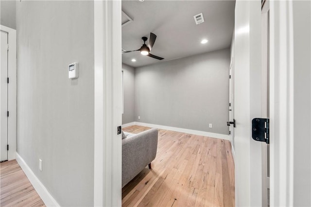 home theater with light hardwood / wood-style flooring and ceiling fan