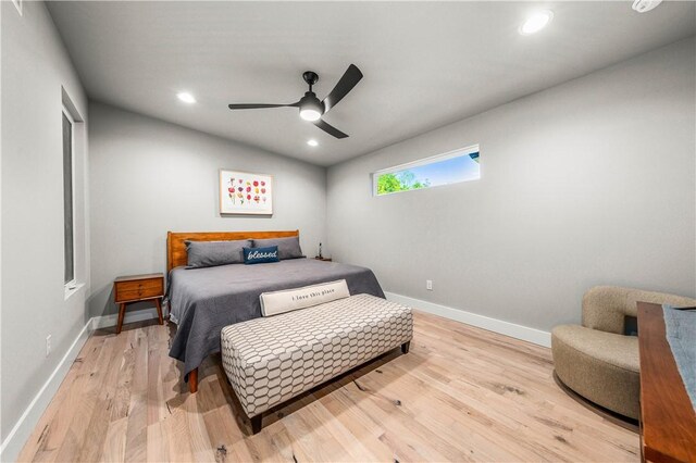 bedroom with ceiling fan and light hardwood / wood-style flooring