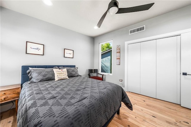 bedroom featuring a closet, light hardwood / wood-style floors, and ceiling fan