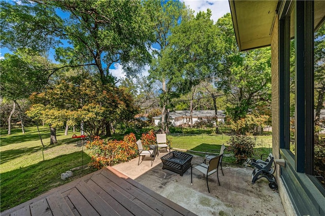 deck with a yard, a patio, and an outdoor fire pit