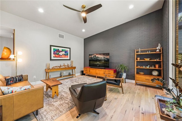 living room featuring ceiling fan and light hardwood / wood-style flooring