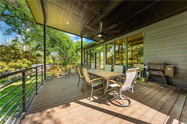 wooden deck featuring a grill and ceiling fan