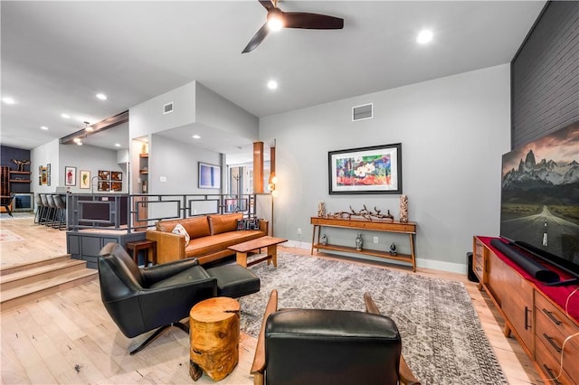 living room featuring ceiling fan and light hardwood / wood-style flooring