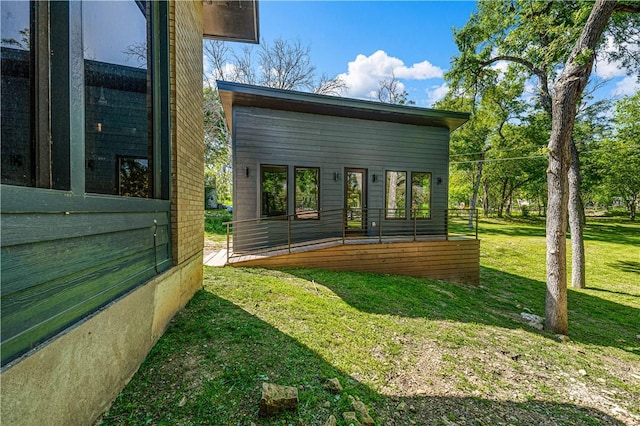 view of side of home featuring a lawn