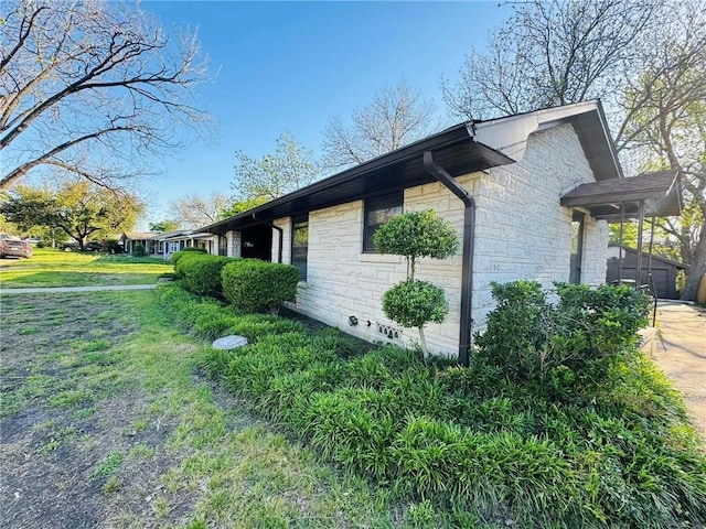 view of side of home with a lawn