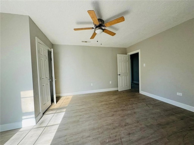 unfurnished bedroom featuring ceiling fan, light hardwood / wood-style floors, and a textured ceiling