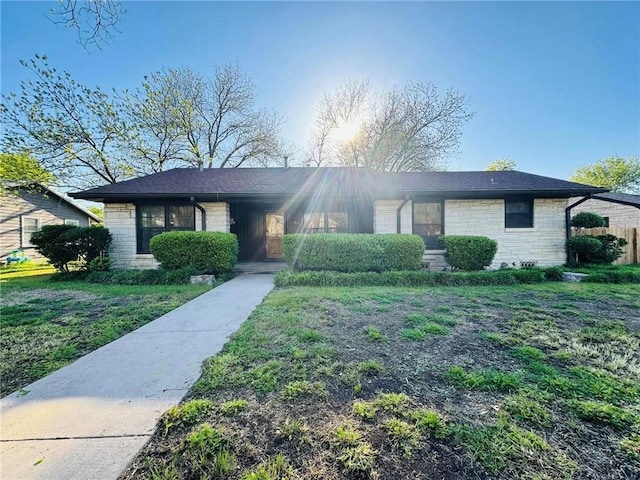 ranch-style house with a front lawn