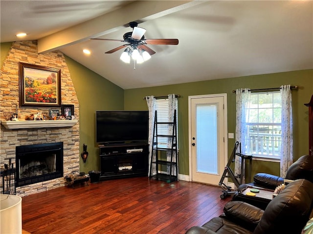 living room with lofted ceiling with beams, a fireplace, ceiling fan, and dark wood-type flooring