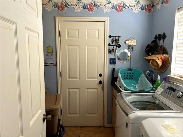 washroom with washing machine and clothes dryer and light tile patterned floors