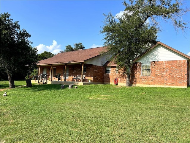 back of property featuring a lawn