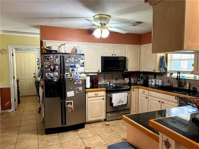 kitchen with sink, ceiling fan, appliances with stainless steel finishes, tasteful backsplash, and light tile patterned flooring