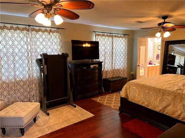 bedroom with dark hardwood / wood-style floors, ceiling fan, and connected bathroom