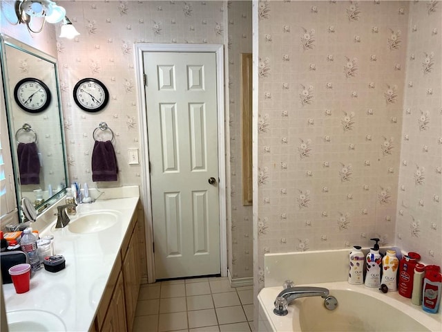 bathroom with tile patterned floors, vanity, and a bath