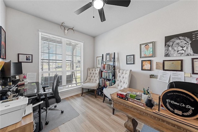 office area with light hardwood / wood-style floors and ceiling fan