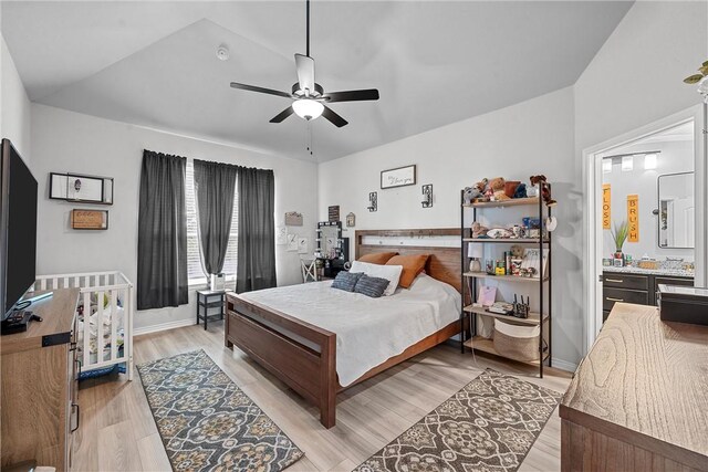 bedroom featuring ceiling fan, light wood-type flooring, and lofted ceiling