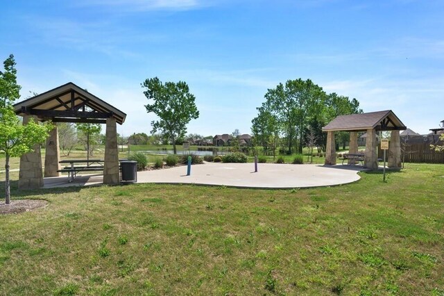 view of property's community featuring a gazebo, a yard, and a water view