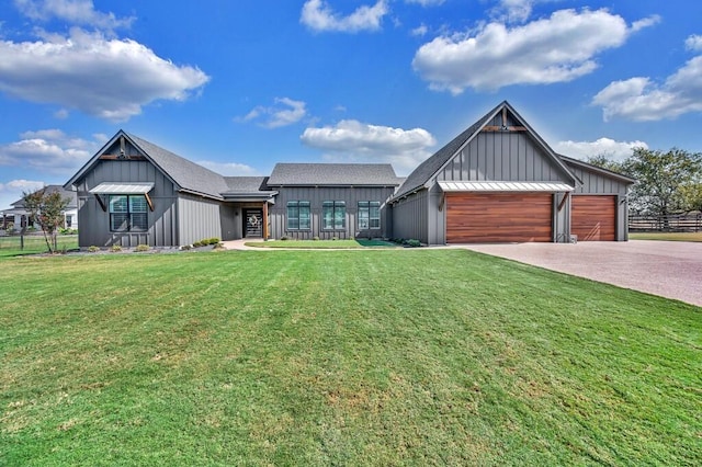 view of front of home with a garage and a front lawn