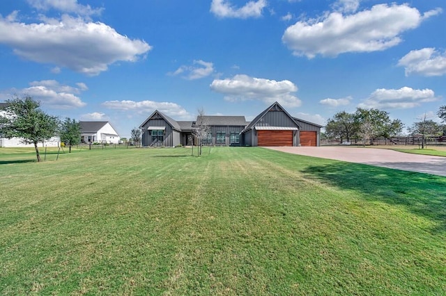 view of front of property with an outbuilding, a garage, and a front lawn