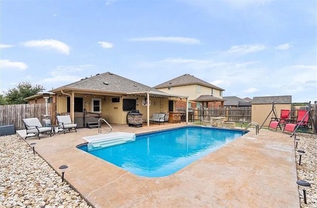 view of pool featuring a hot tub and a patio area