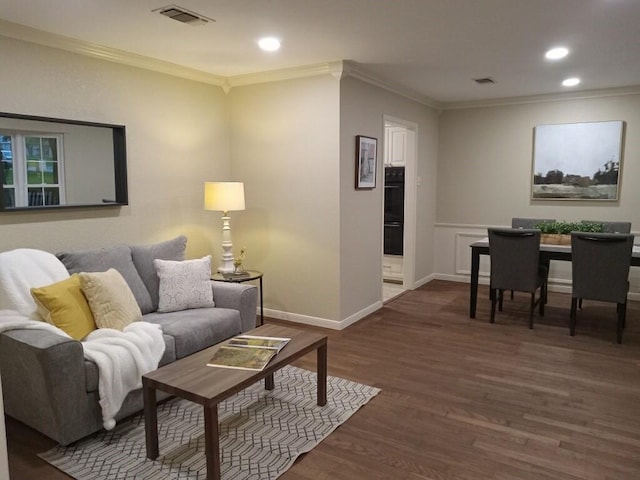 living room featuring dark hardwood / wood-style flooring and ornamental molding