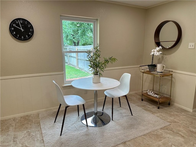 dining space with ornamental molding