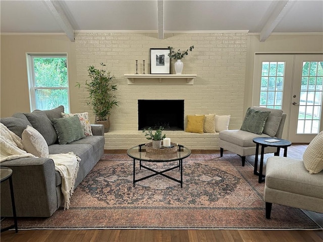 living room with hardwood / wood-style flooring, plenty of natural light, and beam ceiling