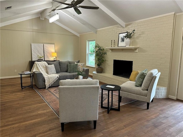 living room with vaulted ceiling with beams, ceiling fan, and dark wood-type flooring