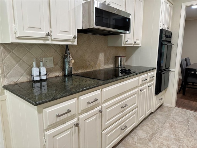 kitchen with white cabinets, decorative backsplash, black electric cooktop, and dark stone countertops