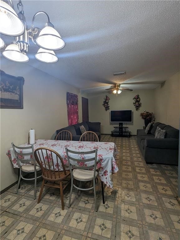 dining room featuring a ceiling fan, visible vents, a textured ceiling, and tile patterned floors