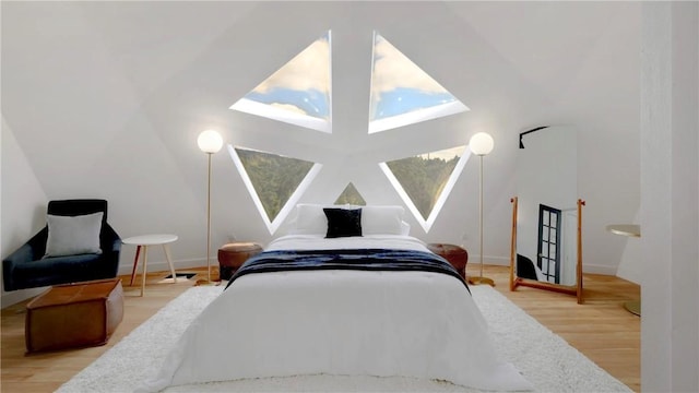 bedroom featuring vaulted ceiling and hardwood / wood-style floors