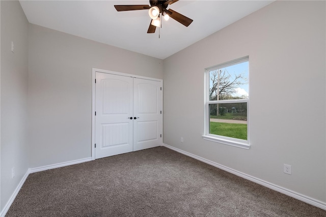 unfurnished bedroom featuring carpet flooring, ceiling fan, and a closet