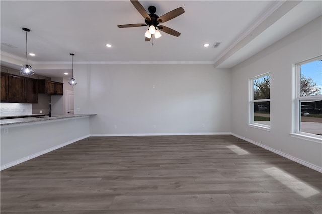 unfurnished living room with hardwood / wood-style flooring, ceiling fan, and crown molding