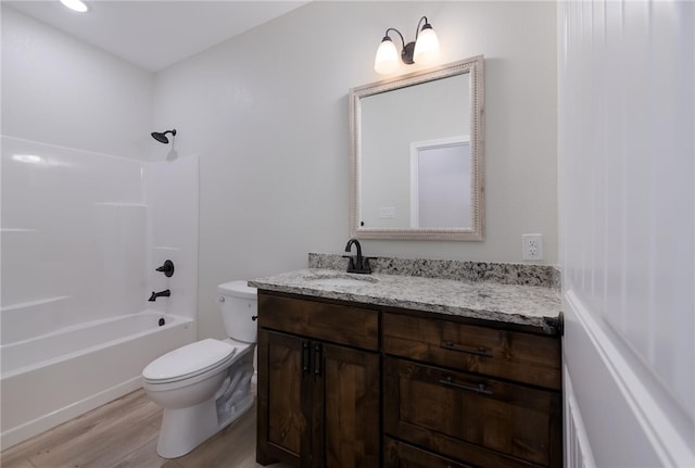 full bathroom with vanity, wood-type flooring,  shower combination, and toilet