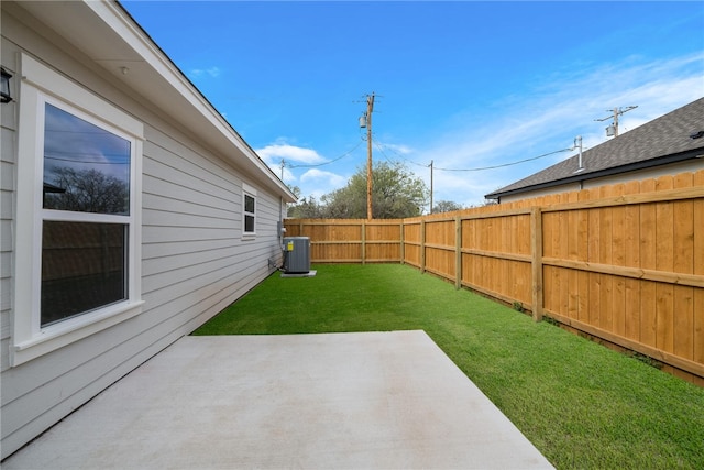 view of yard featuring central AC unit and a patio area