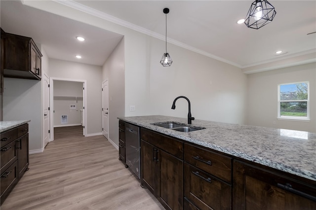 kitchen featuring pendant lighting, light stone countertops, sink, and light hardwood / wood-style flooring