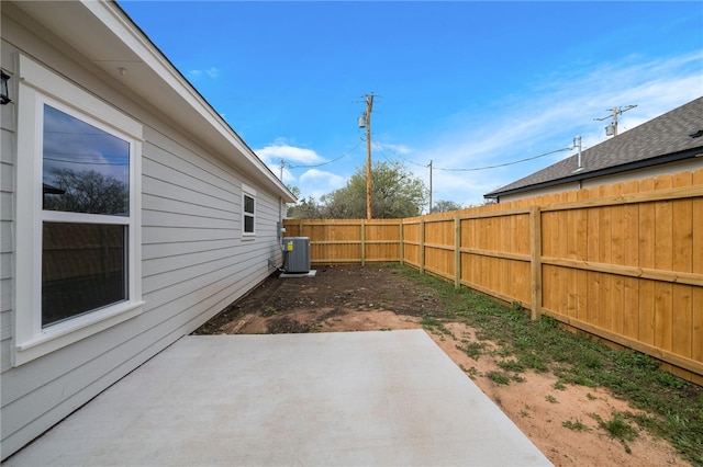 view of yard with central AC and a patio area