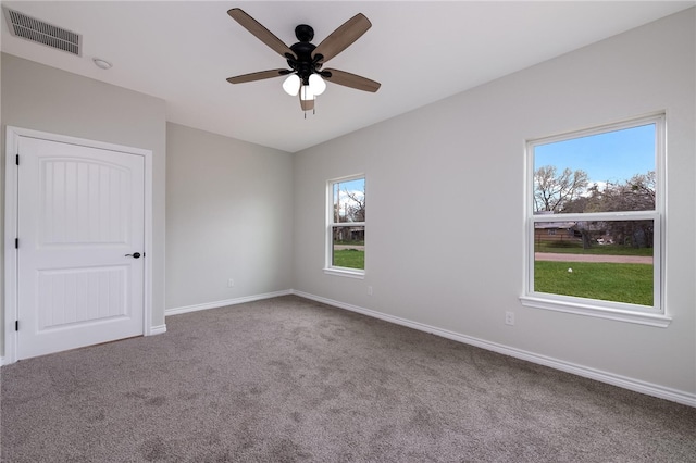 spare room with carpet, ceiling fan, and a healthy amount of sunlight