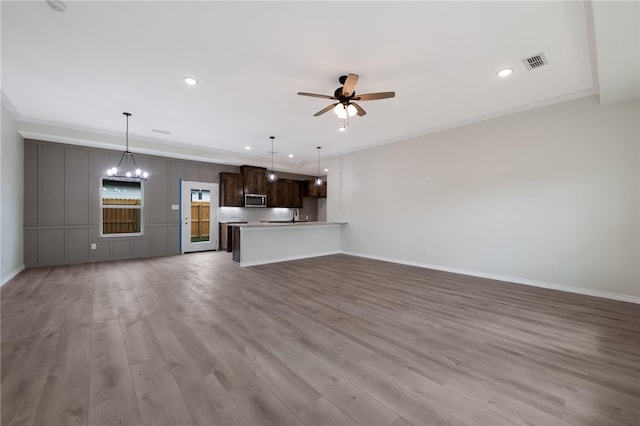 unfurnished living room featuring light wood-type flooring, ceiling fan with notable chandelier, and ornamental molding